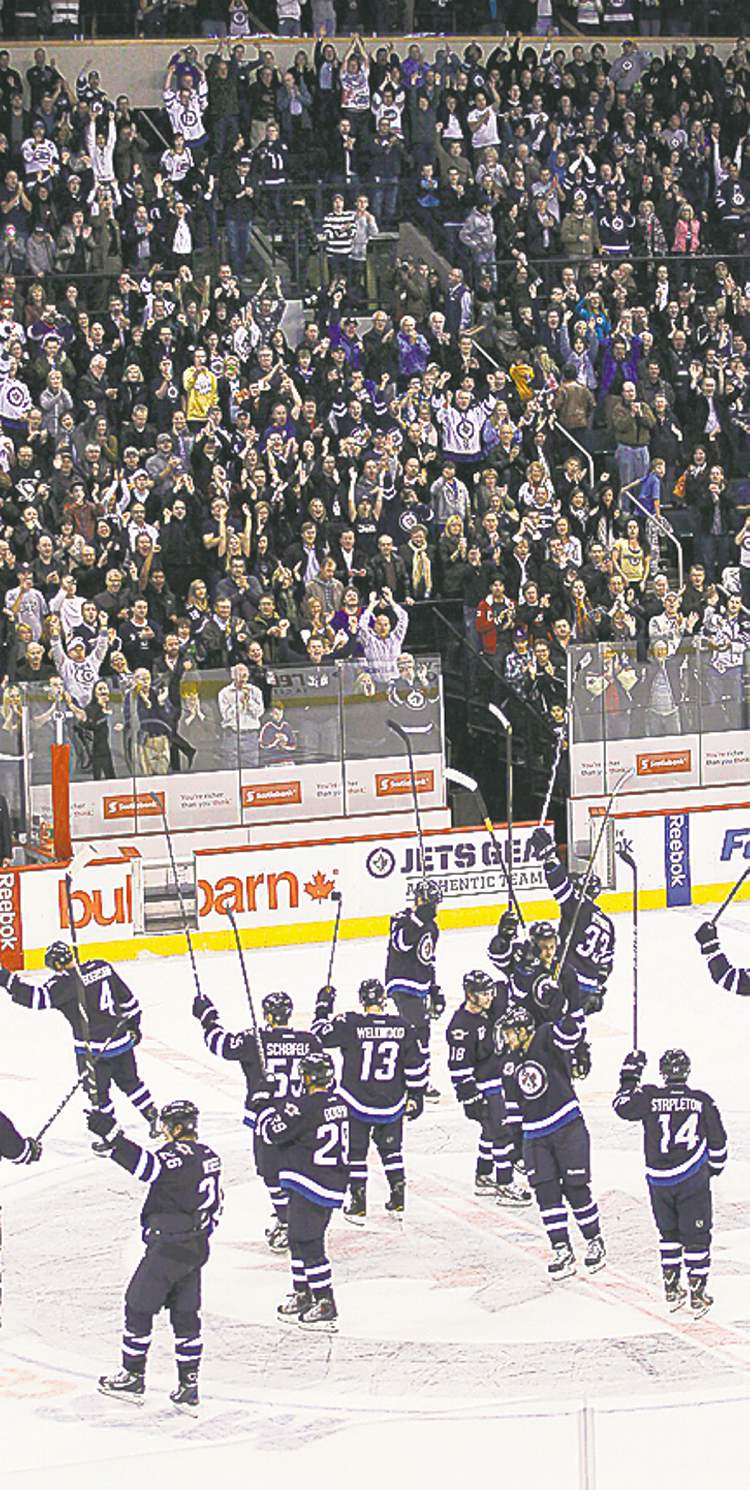 Trevor Hagan/Winnipeg Free Press Archives
Winnipeg Jets salute fans after giving them their first win against the Pittsburgh Penguins at the MTS Centre on Oct. 17, 2011/