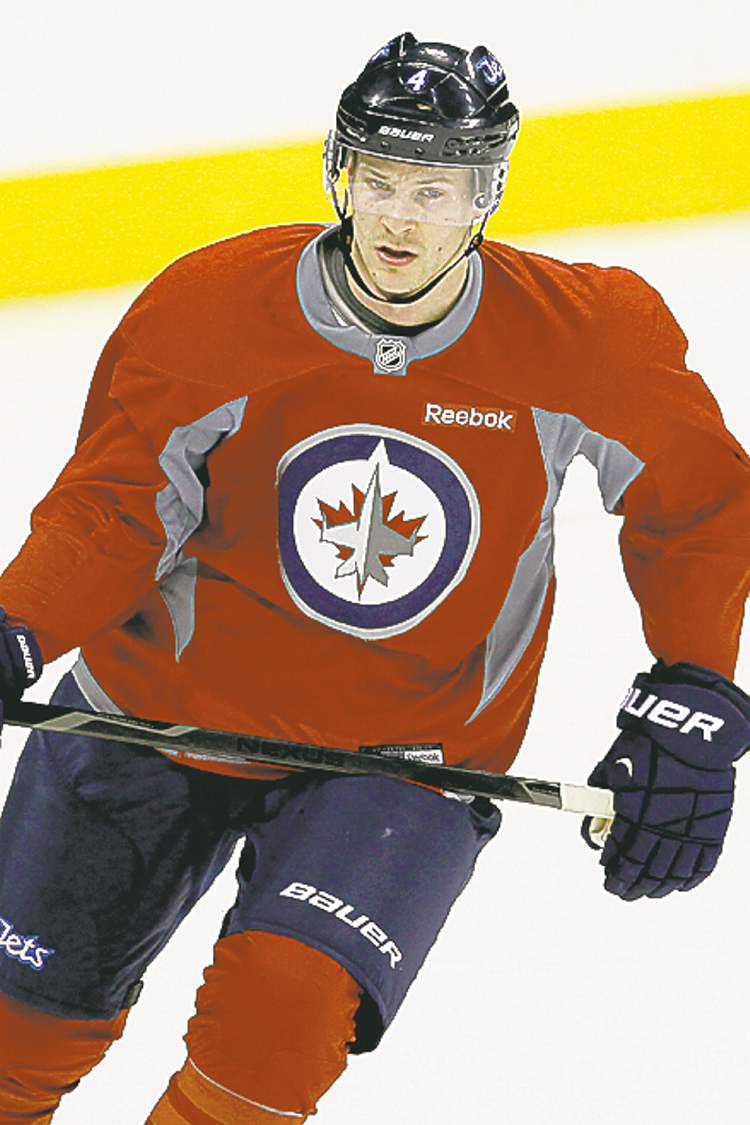 CP
Winnipeg Jets' Paul Postma (4) skates on day three of training camp in Winnipeg on Tuesday, January 15, 2013. THE CANADIAN PRESS/John Woods