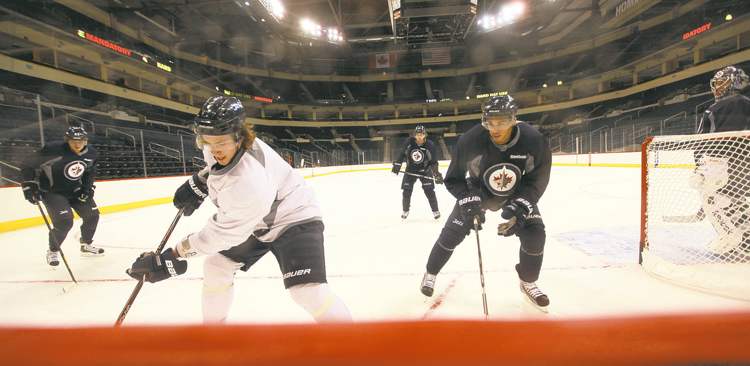 ruth bonneville / winnipeg free press
Alexander Burmistrov (left) and Evander Kane skate during yesterday's informal workout at the MTS Centre.