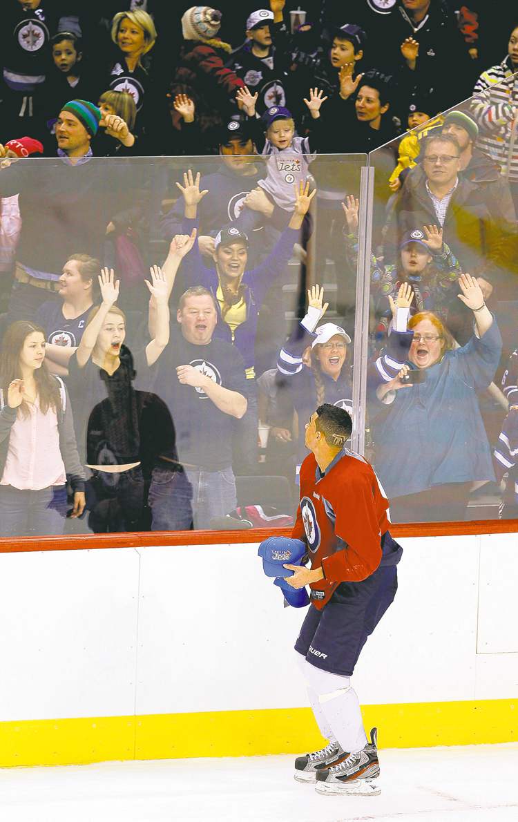 John Woods / The Canadian Press
Winnipeg Jets forward Evander Kane throws hats to fans on opening day of training camp at the MTS Centre on Sunday.