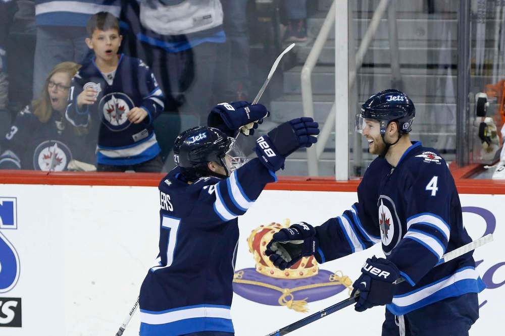John Woods
/ The Canadian Press
Winnipeg Jets' Nikolaj Ehlers (27) and Paul Postma (4) celebrate Postma's goal against the Los Angeles Kings during third period NHL action in Winnipeg on Thursday, March 24, 2016.