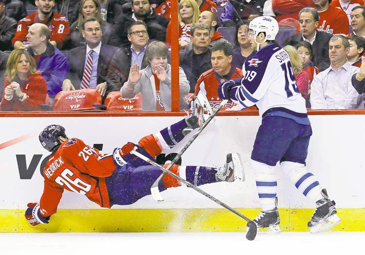 CP
Alex Brandon / the associated press
Capitals centre Matt Hendricks (left) crumples to the ice after a thunderous check from Jets forward Jim Slater during first-period action at the Verizon Center.