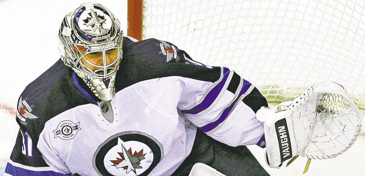 CP
TOP HALF CLOSE CUT CLOSECUT - Winnipeg Jets goalie Ondrej Pavelec (31), of the Czech Republic, blocks a shot from Washington Capitals defenseman Dennis Wideman (6) during the second period of an NHL hockey game in Washington, on Thursday, Feb. 9, 2012. (AP Photo/Jacquelyn Martin)