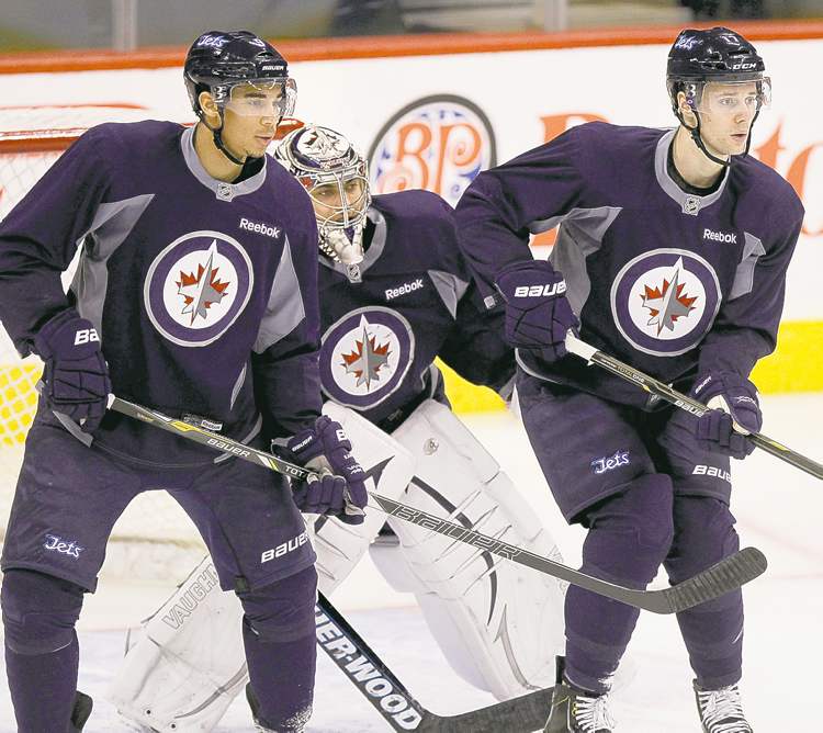 WAYNE GLOWACKI / WINNIPEG FREE PRESS
Goalie Ondrej Pavelec finds some daylight between forwards Evander Kane (left) and James Wright during a workout at the MTS Centre Thursday.