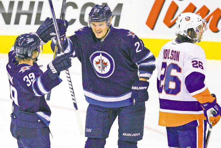 WINNIPEG FREE PRESS
John Woods / WINNIPEG FREE PRESS
Jets Alexei Ponikarovsky (right) and Tobias Enstrom celebrate Ponikarovsky�s first-period goal against the New York Islanders.
