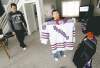 JOE BRYKSA / WINNIPEG FREE PRESS archives
Daimon Gardner, 9, who lives in Warroad, Minn., and plays on the Warroad squirt team, displays his jersey as dad Vince looks on.  as dad Vince looks on.