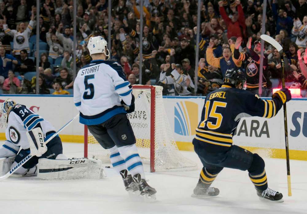 Gary Wiepert / The Associated Press
Winnipeg Jets' Michael Hutchinson (34) and Mark Stuart (5) react as Buffalo Sabres' Jack Eichel (15) celebrates his game-winning goal during the third period of an NHL hockey game, Saturday, March 26, 2016, in Buffalo, N.Y. Buffalo won 3-2.