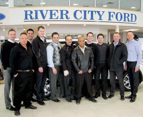 River City Ford dealer principal Trevor Boquist (far right) and general sales manager Ryan Monczunski (fifth from left) with sales staff.