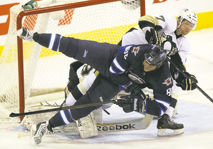 Penguins 3 Jets 1
Pittsburgh's Paul Martin ensures Winnipeg's Nik Antropov is a non-factor, upending the Jet in front of the Penguins net Friday night at the MTS Centre.
