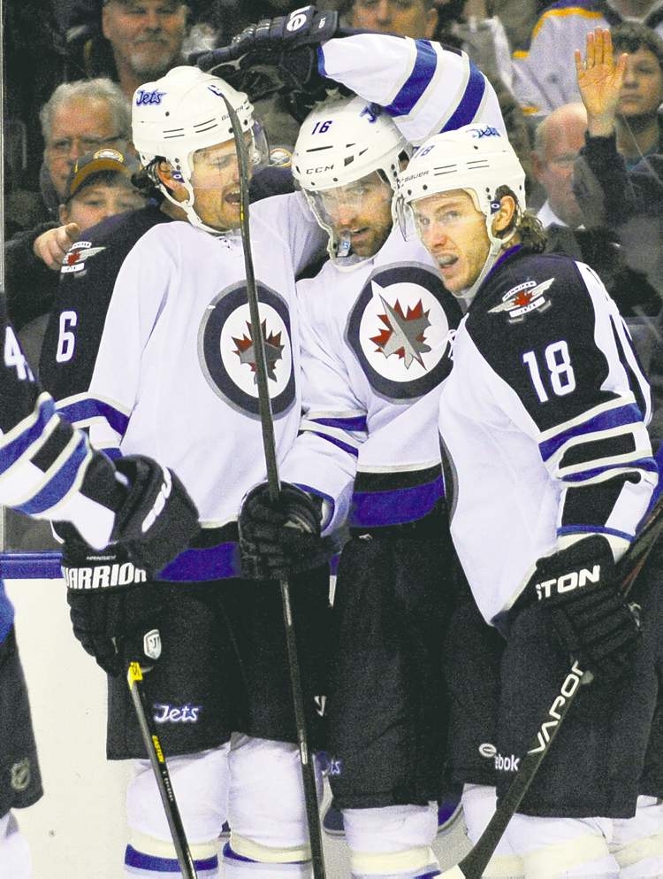 CP
Gary wiepert / the associated press
Winnipeg Jets defenceman Ron Hainsey (6), left-winger Andrew Ladd (16) and centre Brian Little (18) celebrate Ladd�s winning goal in the second period Tuesday in Buffalo.