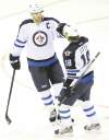 CP
Winnipeg Jets captain Andrew Ladd (left)  celebrates his insurance marker with Bryan Little  during the third period Sunday.