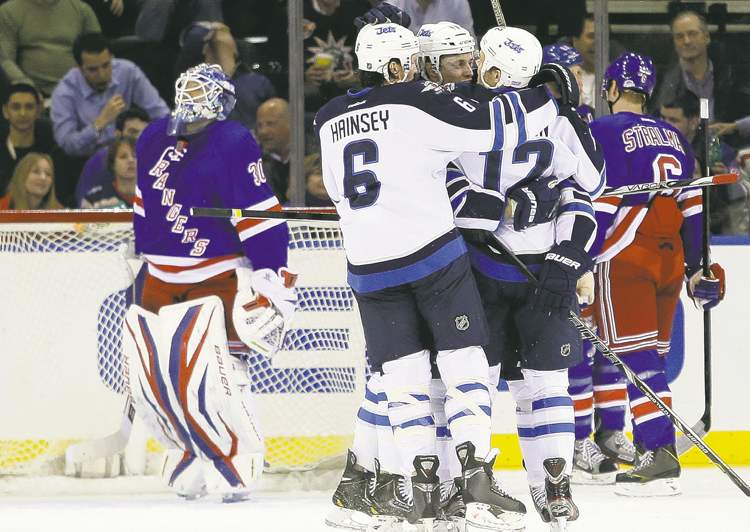 CP
Frank Franklin II / the associated press
Winnipeg�s Ron Hainsey congratulates Olli Jokinen (12) after one of the Finnish centre�s two goals Tuesday night at Madison Square Garden.
