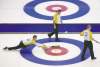 CP
Jonathan Hayward / The Canadian PressManitoba skip Jeff Stoughton releases a shot as second Reid Carruthers (centre) and lead Mark Nichols man the brushes Monday afternoon in a game against Quebec.