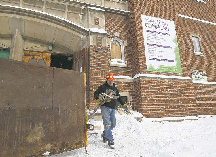 JOE BRYKSA / WINNIPEG FREE PRESS
A worker removes debris from St. Matthew's Anglican Church. The historic church will contain affordable housing and is now called WestEnd Commons.