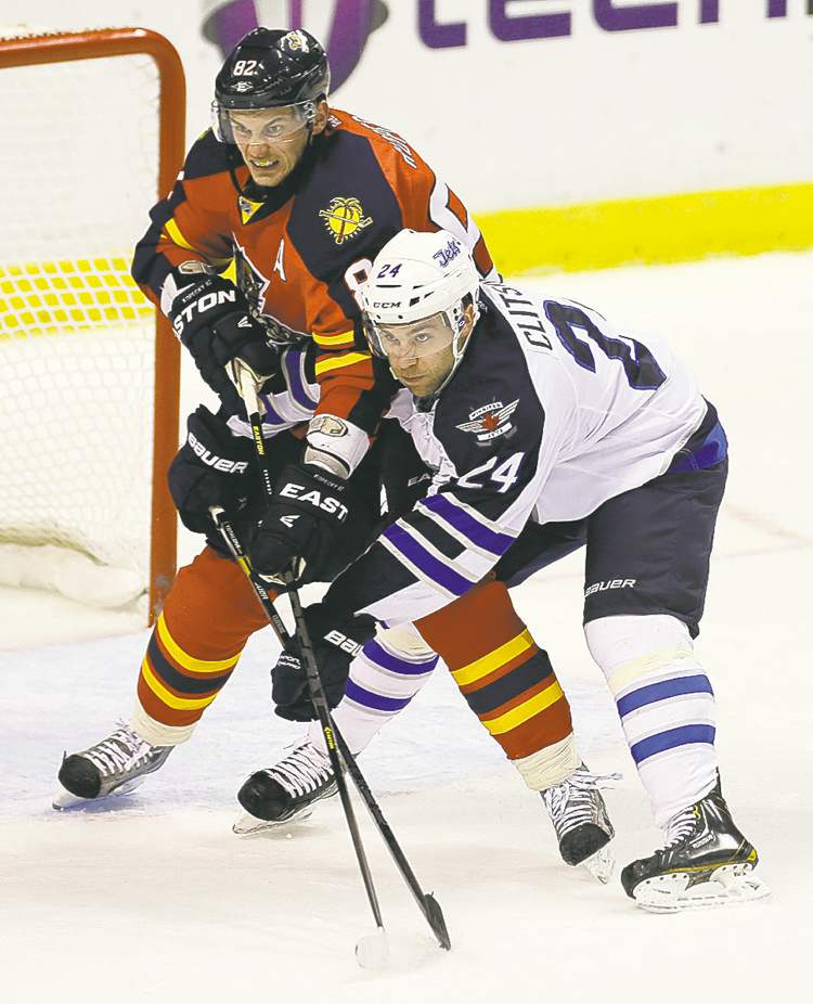 J Pat Carter / the associated press
The Panthers' Tomas Kopecky (left) and the Jets' Grant Clitsome jostle for position in front of the goal during the first period Tuesday evening.