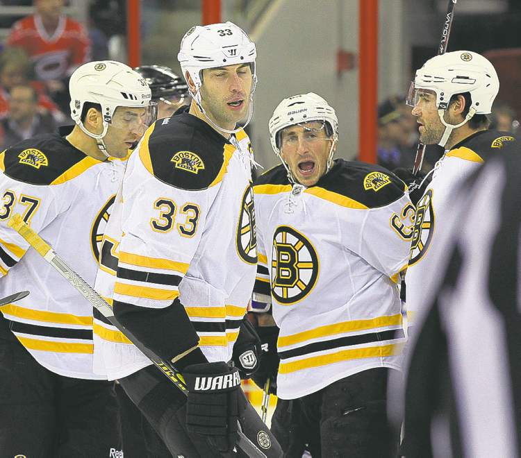 Tribune Media MCT
Boston Bruins' Brad Marchand (63) celebrates his goal with Patrice Bergeron (37) and Zdeno Chara (33) during the first period of an NHL game against the Carolina Hurricanes at PNC Arena in Raleigh, North Carolina, Monday, January 28, 2013. (Chris Seward/Raleigh News & Observer/MCT)