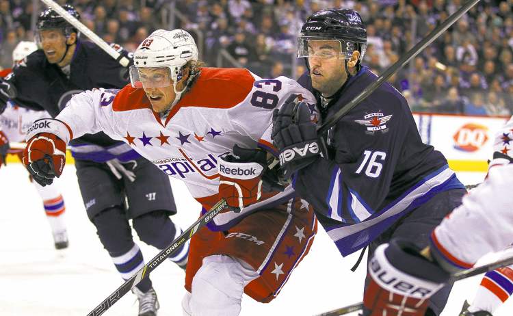 Phil Hossack / Winnipeg Free Press
Winnipeg's Andrew Ladd and the Capitals' Jay Beagle fight for position in the second period at the MTS Centre Thursday night.