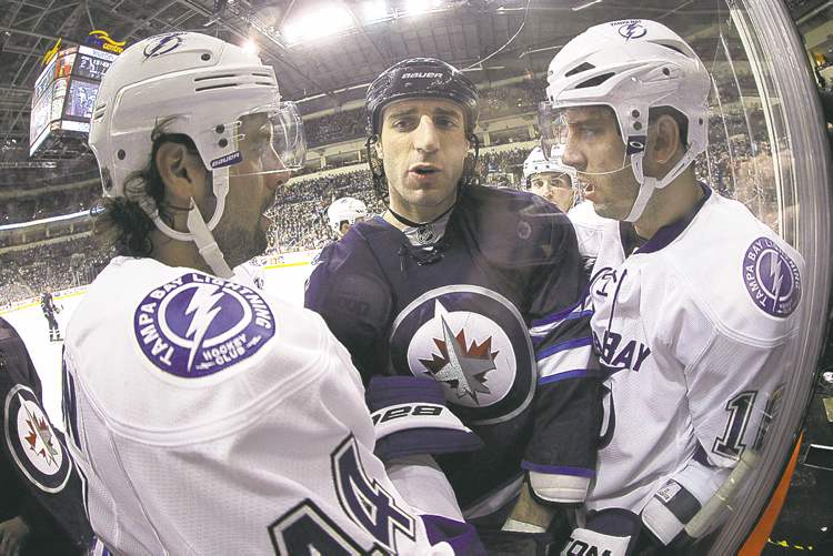 Trevor Hagan / The Canadian Press
Tampa Bay's Nate Thompson (left) and Teddy Purcell have some friendly words for Winnipeg's Chris Thorburn during the second period Sunday.