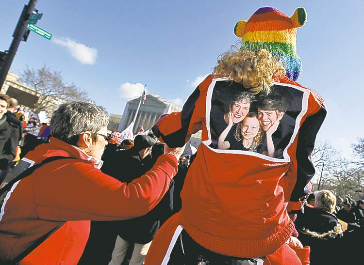 Tribune Media MCT
Molly Riley / MCT
Demonstrators gather outside the U.S. Supreme Court in Washington, D.C., as arguments were heard Tuesday on California�s ban on same-sex marriage.