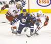 TREVOR HAGAN / WINNIPEG FREE PRESS
Winnipeg�s Olli Jokinen tries to hold up Carolina�s Jordan Staal (left) and Patrick Dwyer during the third period Saturday.