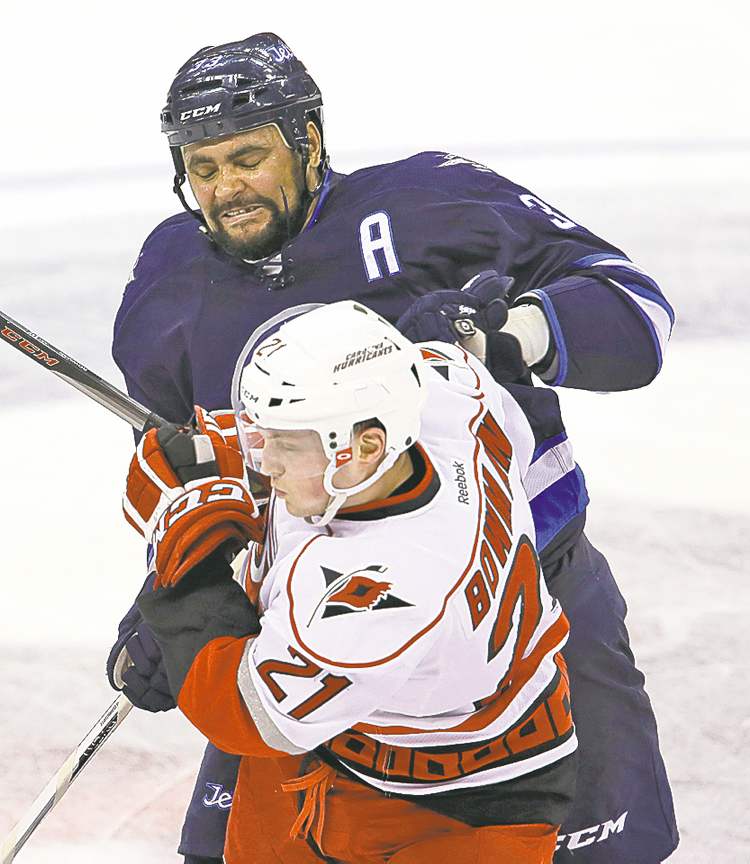TREVOR HAGAN/FREE PRESS ARCHIVES
Dustin Byfuglien, tussling with 'Canes' Drayson Bowman Saturday, isn't worried about a trade.