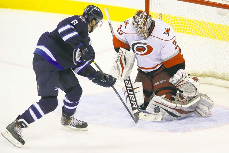 trevor hagan / winnipeg free press
Defenceman Ron Hainsey had perhaps his best chance to score his first goal as a Winnipeg Jet Saturday, but Hurricanes goalie Justin Peters shut the door.
