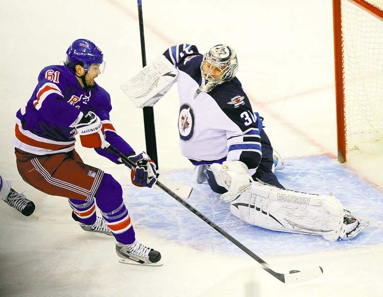 Bill Kostroun / The Canadian Press
New York's Rick Nash was left alone against Jets netminder Ondrej Pavelec in the third period and he made no mistake, putting the Rangers up 4-2.