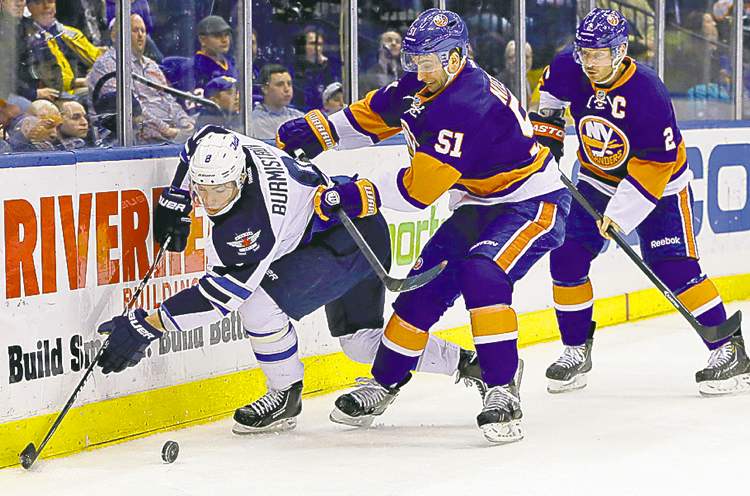 CP
Jets� Alex Burmistrov is double-teamed by Islanders Frans Nielsen (51) and Mark Streit (2) in the third period.