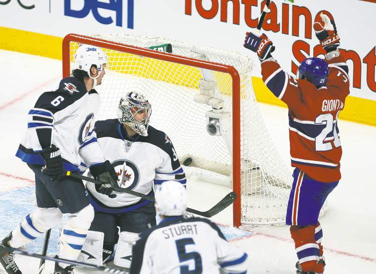 Christinne Muschi / REUTERS
Montreal's Brian Gionta celebrates his goal over Jets goalie Ondrej Pavelec during second-period NHL action at the Bell Centre.