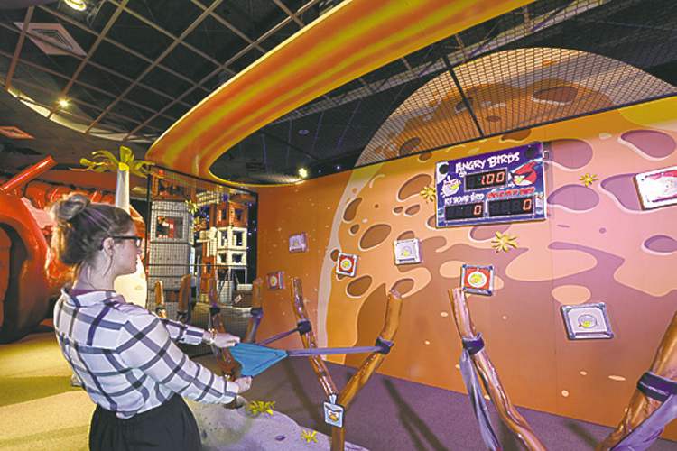AP
Mini-Angry Birds are launched in a slingshot to zap space pigs at the Kennedy Space Center Visitor Complex. The online game Angry Birds is the inspiration for the new attraction at the space center, where most of the exhibits focus on space exploration and NASA history.