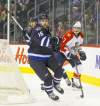 phil hossack / winnipeg free press
Winnipeg Jets captain Andrew Ladd wheels around Dmitry Kulikov behind the Panthers' net in the second period Thursday.