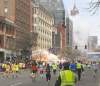 Dan Lampariello / Reuters
Runners head toward the finish line of the Boston Marathon Monday as an explosion erupts.