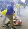 CP
John Tlumacki / The Associated Press Bill Iffrig, 78, receives help as police react to a second explosion at the finish line of the Boston Marathon.