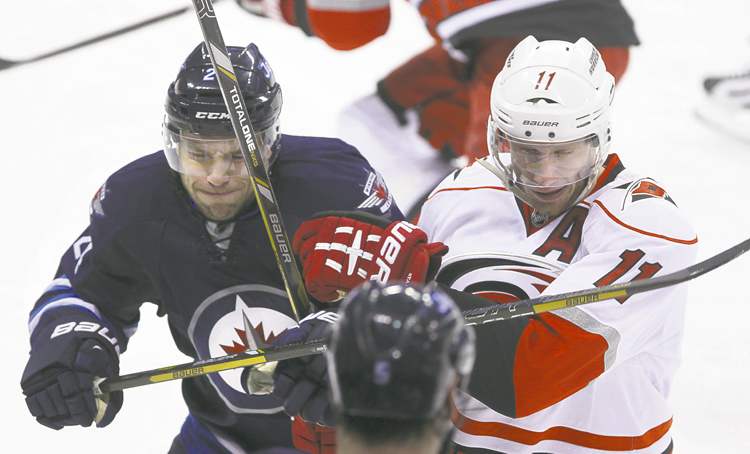 MIKE DEAL / WINNIPEG FREE PRESS
The Jets' Grant Clitsome (left) and the Canes' Jordan Staal collide in first-period action at the MTS Centre Thursday evening.