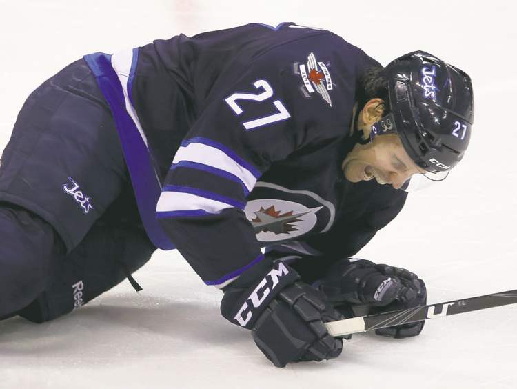 TREVOR HAGAN / WINNIPEG FREE PRESS
Eric Tangradi is in considerable pain after blocking yet another Islander shot.