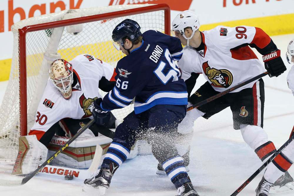 John Woods / The Canadian Press
Ottawa goaltender Andrew Hammond blocks a shot from Jets newcomer Marko Dano during first-period action at the MTS Centre Wednesday night.