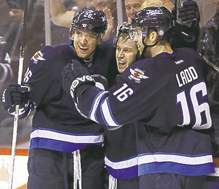 Winnipeg Jets' Blake Wheeler (26), Bryan Little (18) and Andrew Ladd (16) celebrate after Little scored during second period NHL hockey action against the Philadelphia Flyers at MTS Centre in Winnipeg, Saturday, April 6, 2013. (TREVOR HAGAN/WINNIPEG FREE PRESS)