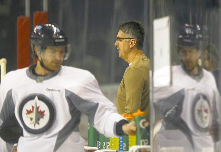 JOE BRYKSA / WINNIPEG FREE PRESS
Jets head coach Claude Noel makes a brief appearance at team's optional practice on Wednesday at the MTS Centre while Jim Slater heads for a breather.