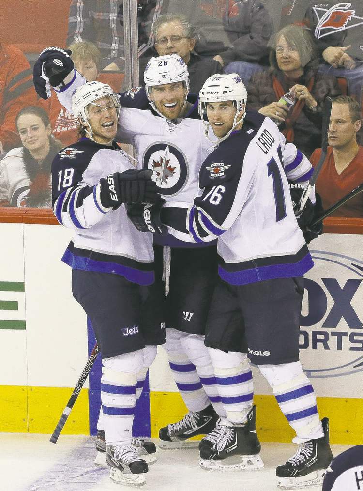 AP
The Big Three: Andrew Ladd (16) wants to keep linemates Bryan Little (18) and Blake Wheeler.