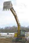 Sarah Rollason-MacAulay plays in the dirt with a full size excavator at Extreme Sandbox in the Twin Cities area.