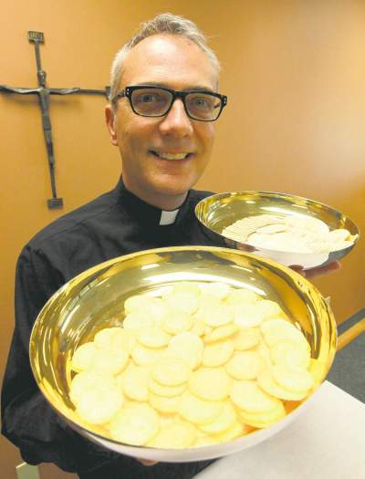 BORIS MINKEVICH / WINNIPEG FREE PRESS 
Father Darrin Gurr of St. Gianna Beretta Molla Roman Catholic Church with low-gluten communion wafers.