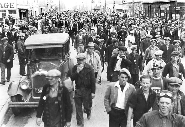 Strikers in an unidentified town head to the trains.