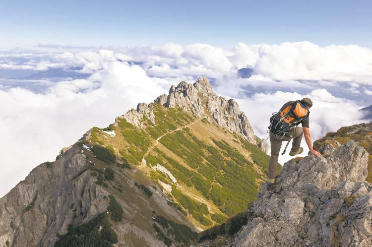 AP
A mountain hiker transcending the Garsellikopf approaches the Three Sisters mountains, seen in background, near Planken, Liechtenstein.
