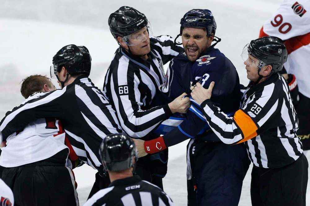 JOHN WOODS / THE CANADIAN PRESS FILES
Dustin Byfuglien (centre) was a marked man after his thunderous bodycheck on Mark Stone Wednesday at the MTS Centre.
