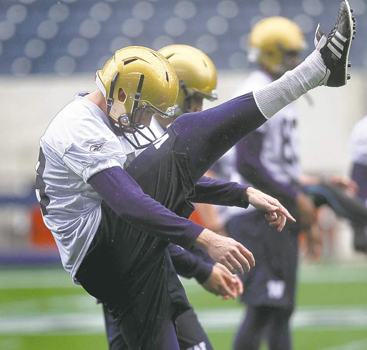 Phil Hossack / Winnipeg Free Press
Tim Hutchison stretches out in the rain Friday.