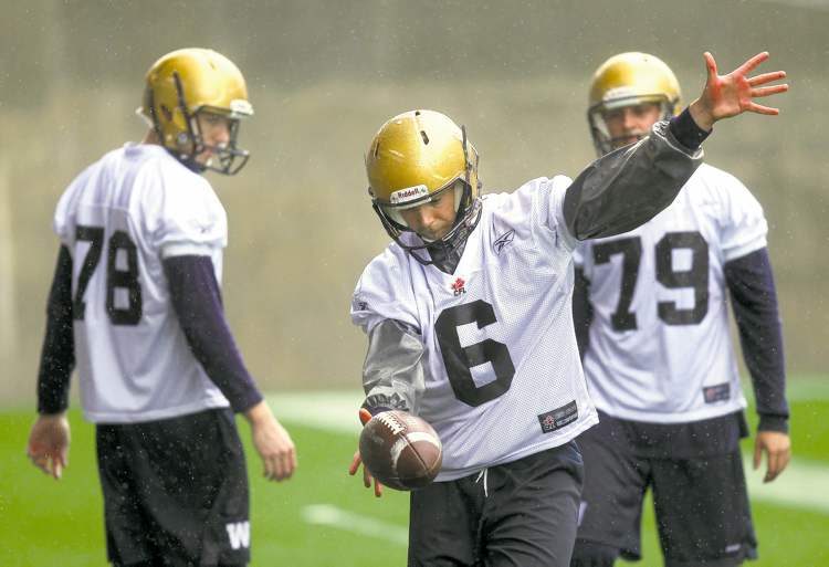 Phil Hossack / Winnipeg Free Press
Bomber rookie kicker Brett Cameron works out the kinks under the gaze of Tim Hutchison (left) and Billy Pavlopoulas Friday at Investors Field.