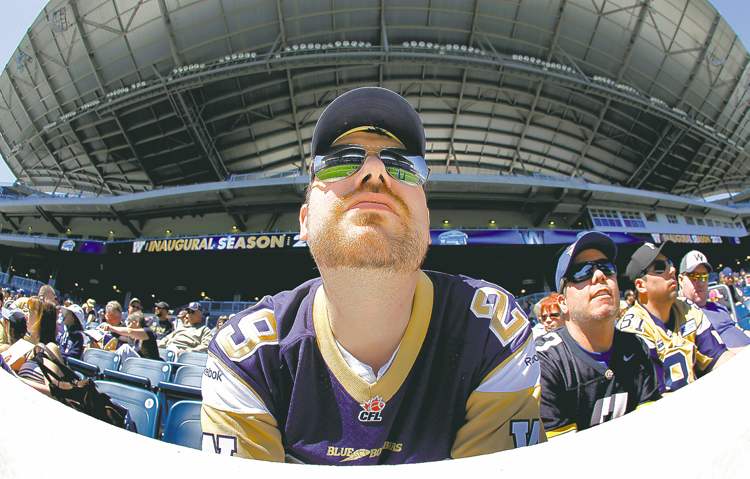 john woods / the canadian press
Season-ticket holder Kevin Carlson checks out the Big Blue at Investors Group Field during opening day of training camp on Sunday.