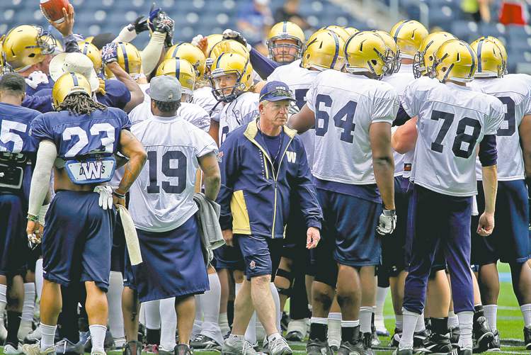 trevor hagan / winnipeg free press
Bombers head coach Tim Burke emerges from a huddle during practice at Investors Group Field, Sunday.
