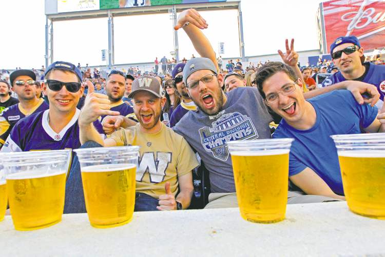 BORIS MINKEVICH / WINNIPEG FREE PRESS
Winnipeg Blue Bombers fans enjoy a few cold ones at their first game at Investors Group Field. Overall, the crowd seemed to enjoy the new digs. Even the Blue cheerleaders were flipping out over the place.