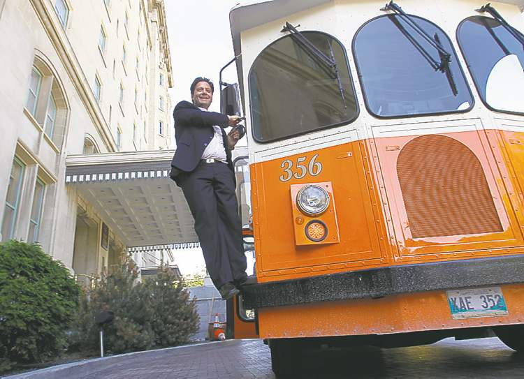 WAYNE GLOWACKI/WINNIPEG FREE PRESS
Stefano Grande, executive director of the Downtown BIZ, poses beside a Winnipeg Trolley Company vehicle to announce new tours.